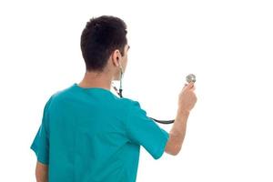 male doctor in uniform with stathoscope posing isolated on white background photo