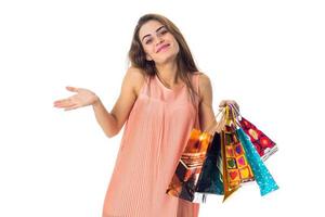 young girl waving hand and keeps the color bright bags isolated on white background photo