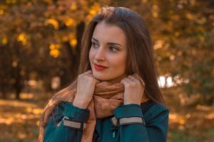cute girl looks away and keeps hands scarf photo