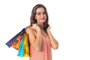 the girl keeps on its shoulder multi colored packets with gifts is isolated  a white background photo