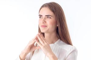 young girl looks up and keeps two hands near individuals is isolated on  white background photo