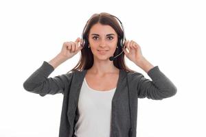 Cutie young business woman working in call center with headphones and microphone looking at the camera and smiling isolated on white background photo