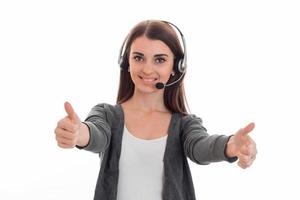 a cheerful young girl in headphones stretched hands forward and shows the class photo