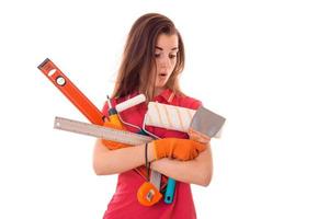 a young girl in a red t-shirt with the surprised face holding a measuring instruments isolated on white background photo