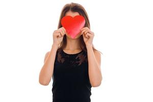 young funny brunette lady with red heart in hands posing isolated on white background. Valentines Day concept. photo
