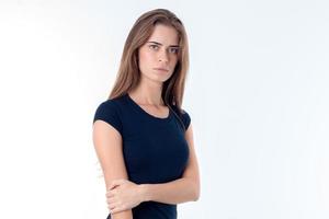 young girl in  black t-shirt stands up straight and keeps hand elbow isolated on white background photo