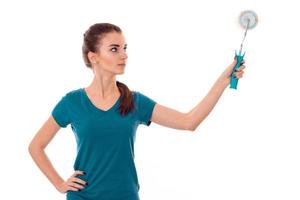 young pretty brunette woman builder in uniform with paint roller in hands make reovations isolated on white background photo