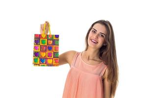 young girl raised up  beautiful gift bag isolated on white background photo