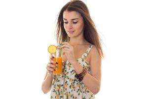 a young girl holds orange juice photo