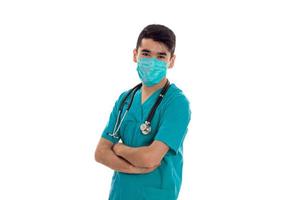 a young doctor in a sling on his face folded hands close-up isolated on white background photo