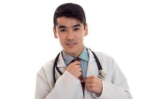 Portrait of a young doctor in a white lab coat close-up isolated on white background photo