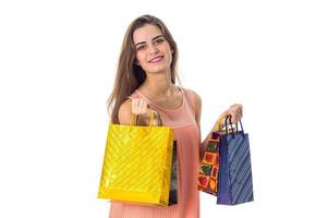 smiling girl holds a different gift bags isolated on white background photo