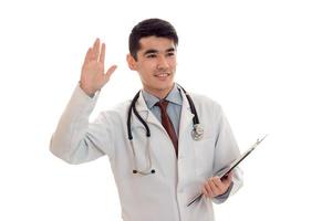 young cute doctor in blue uniform with stethoscope on his neck isolated on white background photo