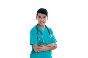 a young doctor with stethoscope looks into the camera and smiling photo