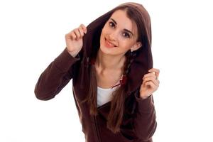 cute teen girl with pigtails in the brown jacket looks into the camera and smiling photo