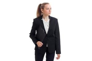 a beautiful young woman in a black business suit looks away and keeps the Tablet photo