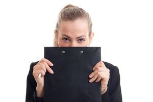 young beautiful girl covers her face and looks into the Tablet Chamber isolated on white background photo