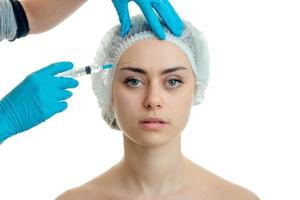 a young girl with a hat on his head and she looks directly make facial filler injections isolated on a white background photo