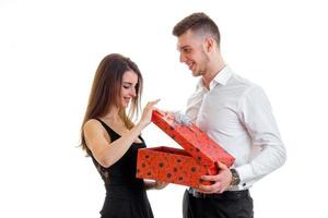 young pretty girl opens a large gift box which brought guy and smiling photo