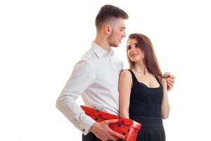 young tall guy in a white shirt brought girl red gift box photo