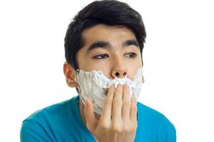 Portrait of a ridiculously young guy that does shaving foam on your face closeup photo