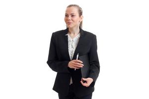 smiling young business woman stands upright in the jacket and holding a folder photo