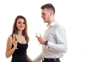 a cheerful young girl in a dress with the smiling guy in a shirt and they are holding wine glasses photo