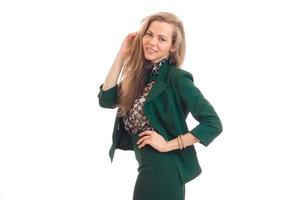 beautiful young girl with blond hair smiling and posing for the camera in a green suit photo