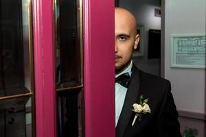 half face portrait of young elegant male in suit photo