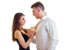 pin-up girl looks at beautiful guy and they keep the champagne glasses close-up
