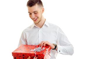 Happy guy opens the gift in red box photo