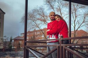 Lovely couple hugs on a balcony winter time photo