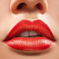 Macro photo of beautiful woman lips with red lipstick