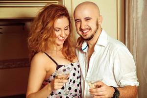 Cute young couple at martini home party photo