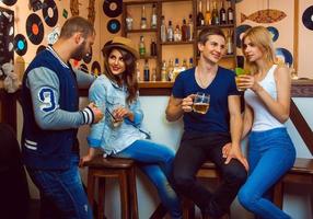 loving couples in a bar drinking and talking to each other photo