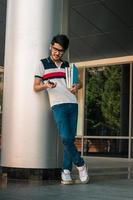 Young smrat student guy with books in hands photo