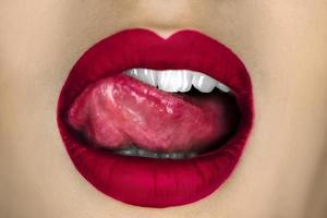 girl sexually licks her red lips photo