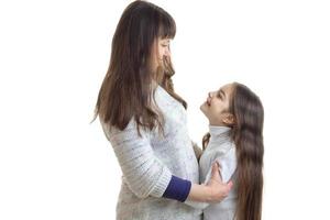 mother and daughter hugging and smiling to each other photo