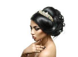 Adorable young brunette girl with crown on creative hairstyle photo