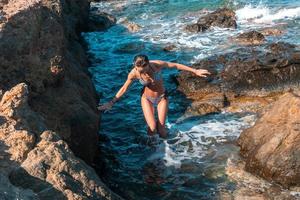 a cheerful young girl swims in the sea photo