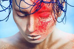 horizontal portrait of sexy woman with neon powder on face in studio photo