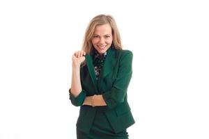 Cheerful attractive blonde business woman in green uniform smiling on camera photo