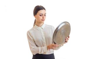 the young waitress holding a large round tray for eating photo