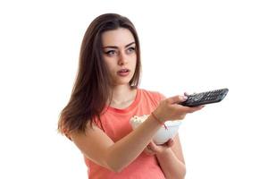 surprised young woman with pop-corn watching a tv photo