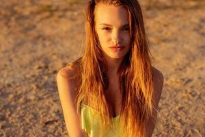 hermosa joven en el mar al atardecer foto