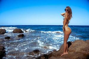 sexy girl in a stunning blue sea photo