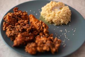 crispy chicken with garnish of porridge photo