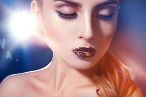 Portrait of cutie young woman with makeup and healthy skin in studio photo