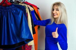 happy girl chooses clothes in shop photo