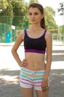 vertical portrait slim fitness girls in short shorts and tank top photo